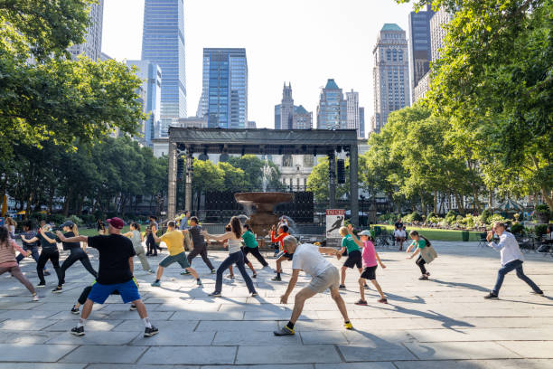 New York, New York, USA - June 18, 2024: This image shows people in a Tai Chi class on the terrace of Bryant Park in midtown Manhattan in New York City.
