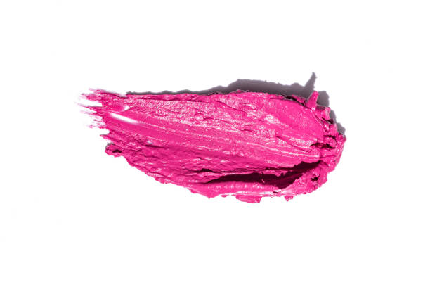 Smudged pink lipstick isolated on white background. Make up product swatch.