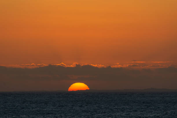 View across tranquil bay to sunset, Seychelles