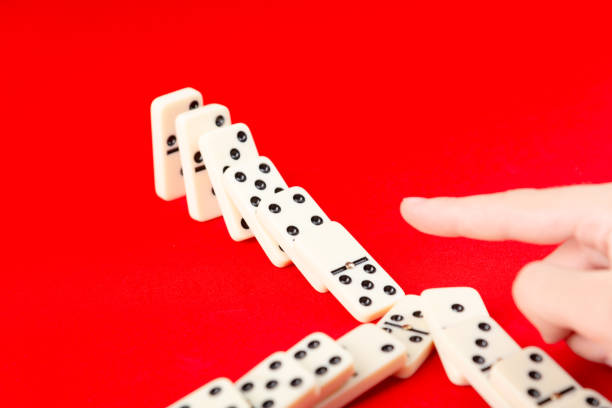 Man hand stop domino effect.