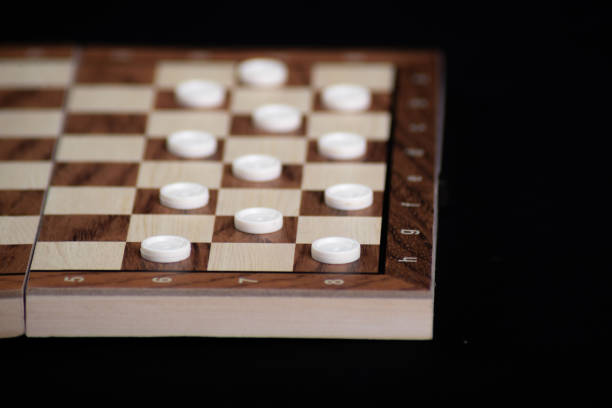 istock Checkerboard with light and dark pieces. Game concept. Board game. Hobby. Checkers on the playing field for a game 2159415691