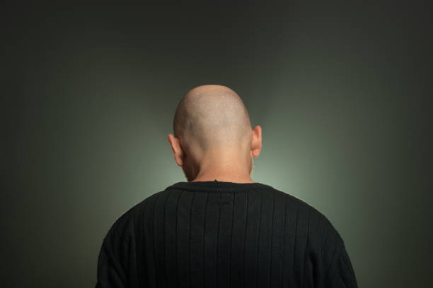 istock Mysterious, middle-aged, bald man in a dark shirt. Photo in studio. 2159416459