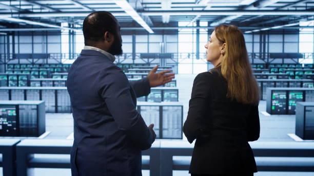 istock Data center engineer presenting equipment to inspector supervising operations 2159416528