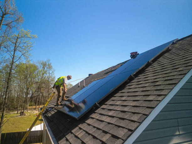 istock Solar Panel Installer - Safety Harness - Private Home - Sustainable Energy - Mounting Panels - Drone POV 2159417124