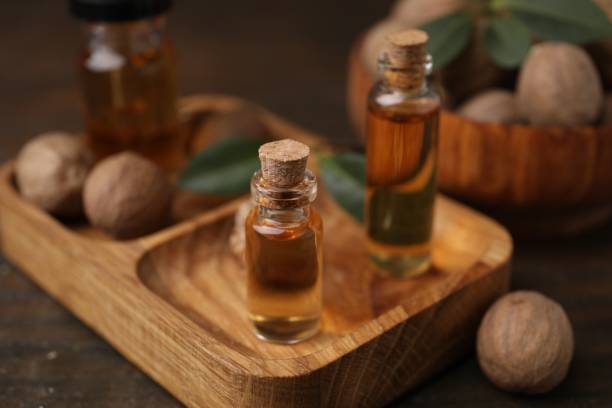 istock Nutmeg essential oil and nuts on wooden table 2159425546