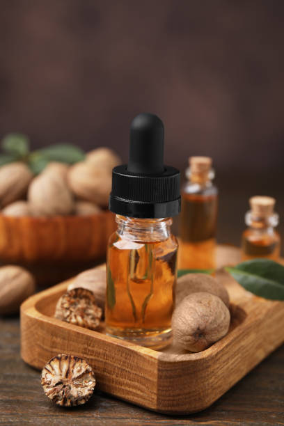 istock Nutmeg essential oil and nuts on wooden table 2159425547