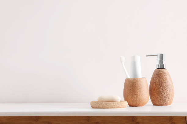 istock Different bath accessories and personal care products on table near white wall, space for text 2159425642