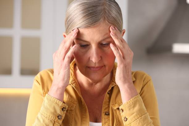 istock Menopause. Woman suffering from headache in kitchen 2159426649
