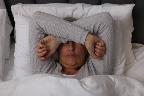 istock Menopause, sleep problems. Woman suffering from insomnia in bed, top view 2159426694
