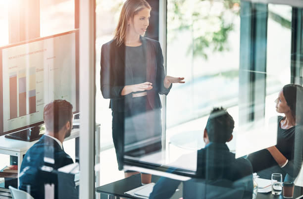 istock Office, discussion and businesswoman with presentation on computer screen, data analysis and graphs. Finance team, female analyst and meeting of report, feedback and statistics review by glass wall 2159428299