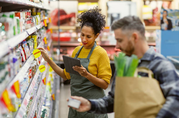 istock Diligent Hispanic Shopping Assistant in Store Aisle 2159431004