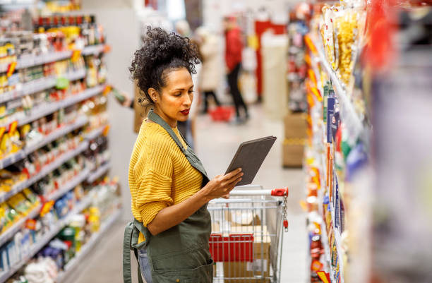 istock Mature Hispanic Shop Assistant in Grocery Aisle 2159431009