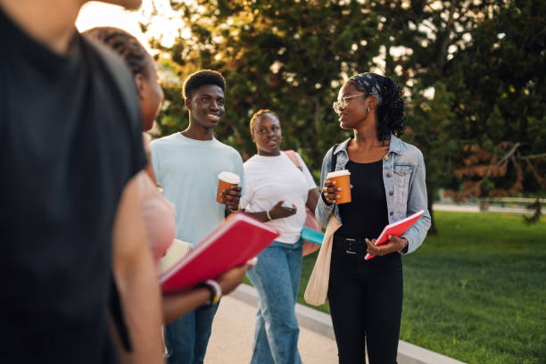 istock Happy diverse college students walking at university campus with coffee 2159431402