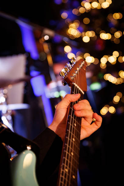 istock Man playing electric guitar with a blurred background with beautiful bokeh 2159432845
