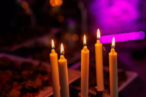 Set of candles burning in a dark room