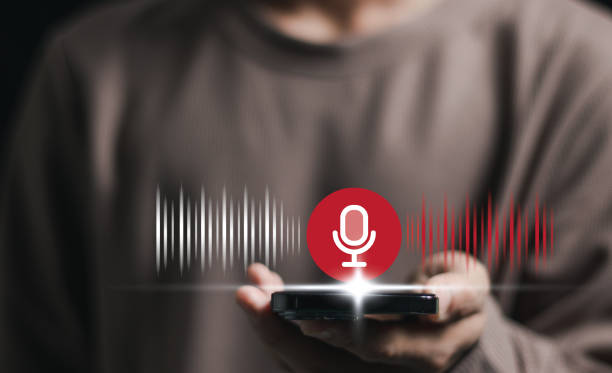 istock Voice recording. Man touching microphone icon on smart phone. Mobile application Record sound, audio, music, voice message. or Use your voice to direct AI to search for information on Internet. 2159434903