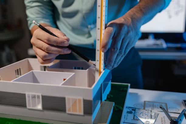 istock an architect is working in the office, an engineer works on house model on the desk, he used his expertise skill and creativity to design the best work for the client 2159437493