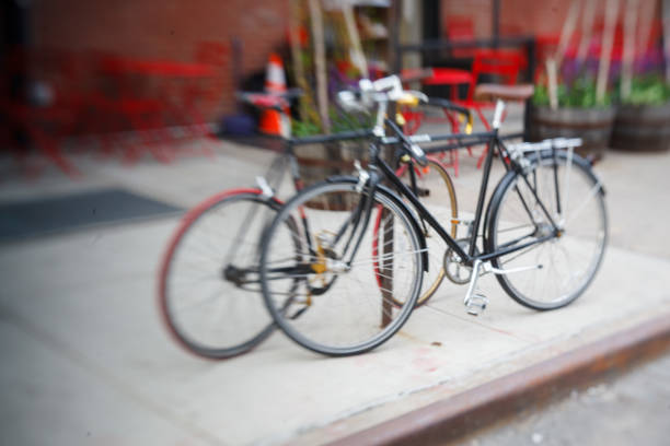 Two bicycles parkes on a sidewalk in Manhattan, New York City