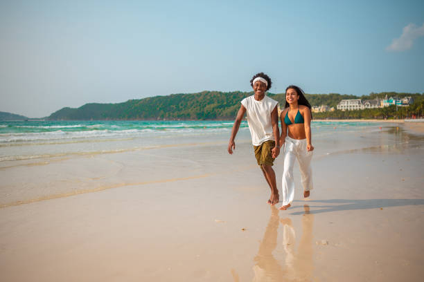 istock Joyful Beach Run of Diverse Young Couple 2159438106