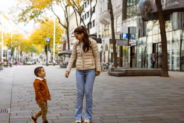 istock Morning Stroll: Mother and Son Walking in the City 2159438549