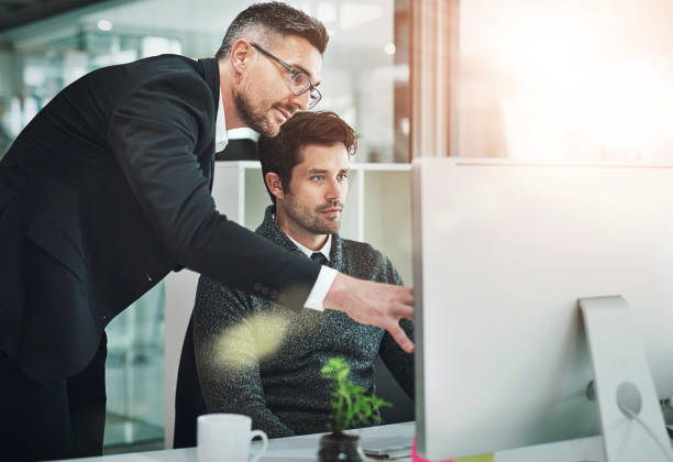 istock Computer, training and business people in office for planning, learning or explain, research and questions. Coaching, pc or man with manager online at digital agency for creative, goal or design help 2159439748