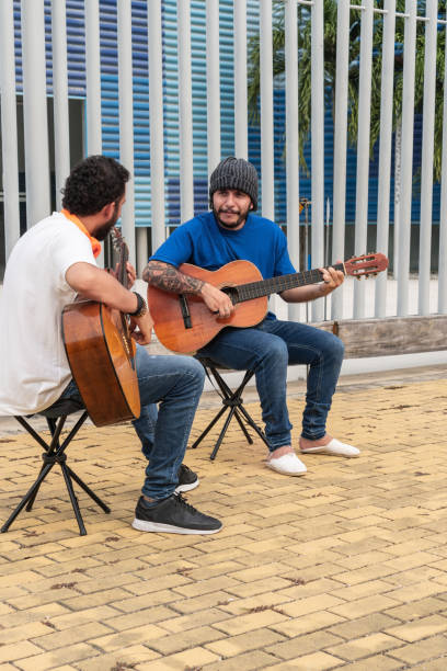 istock Two Musicians Playing Guitars Outdoors on a Sunny Day 2159441138