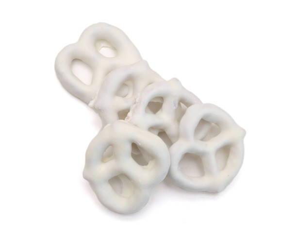 istock White chocolate covered pretzels on white background 2159444341