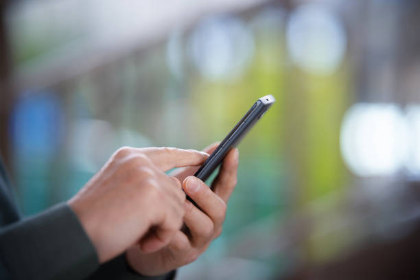 istock Middle-aged man using smartphone in city street 2159445772
