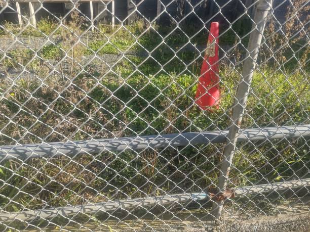 istock Chain fence and road cone 2159446416