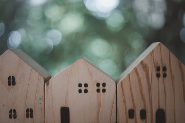 Wood house model against nature background. Purchasing home to live of dream of community lives.