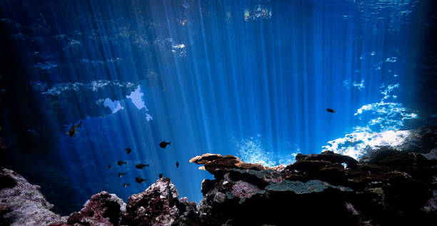 istock Rays of light inside a cave in the deep blue ocean 2159449988