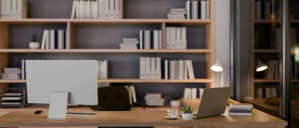 istock A contemporary luxurious private office at night features a computer and a laptop on a table. 2159452100