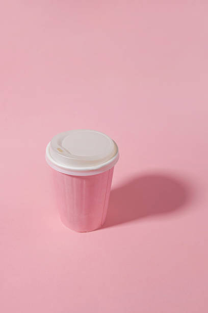 istock Pink paper coffee mug isolated on pastel background 2159453886