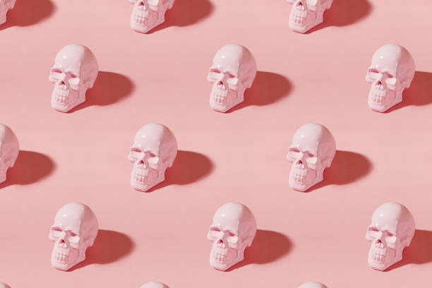 istock Creative Halloween background with pink human skulls and long shadows 2159453992
