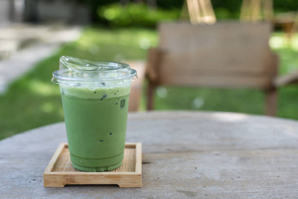 istock Cup of iced matcha green tea on wooden table 2159458241