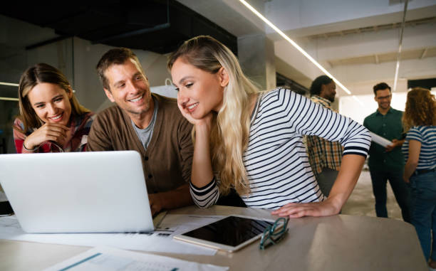 istock Diverse business colleagues gather in boardroom brainstorm discuss financial statistics together 2159462543