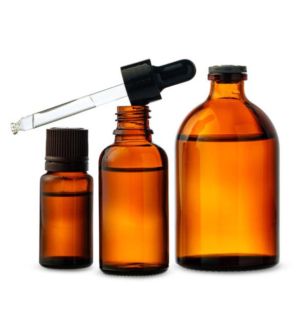 istock Three Amber Glass Dropper Bottles With Dropper Against White Background 2159462599