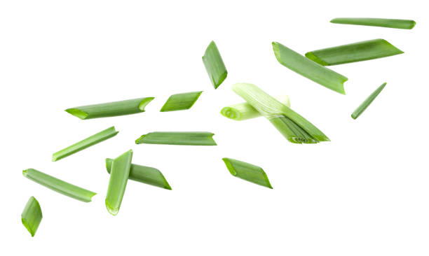 istock flying green onion isolated on white background. clipping path 2159462737