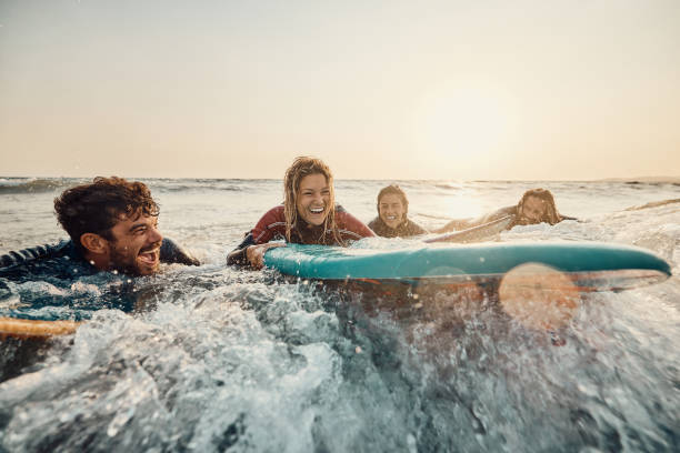 istock Cheerful surfers having fun in summer day at sea. 2159462850