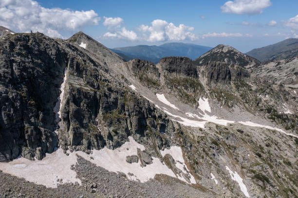 View of the Pirin Mountains and evergreen trees from a hiking trail near Bansko in southeastern Bulgaria