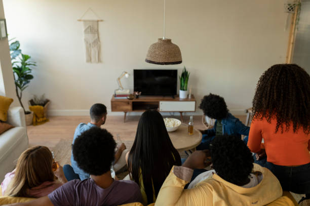 istock Multiracial Friends Watching TV Together at Home 2159464458