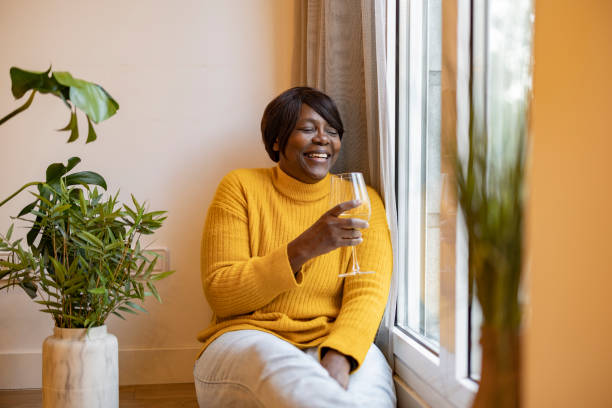 istock Elderly Woman Smiling with a Drink by the Window 2159466786