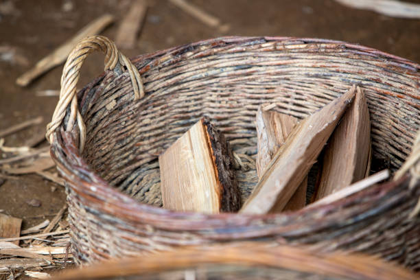 A wicker basket with handles, for carrying several pieces of wood for heating.