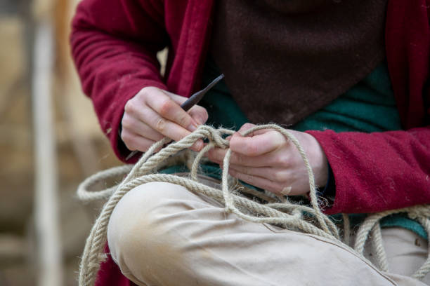 istock Hemp threads braided into rope by hand by a man. 2159467196