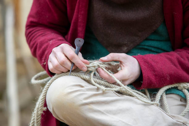 Hemp threads braided into rope by hand by a man.