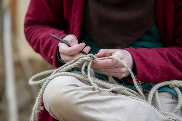 istock Hemp threads braided into rope by hand by a man. 2159467252