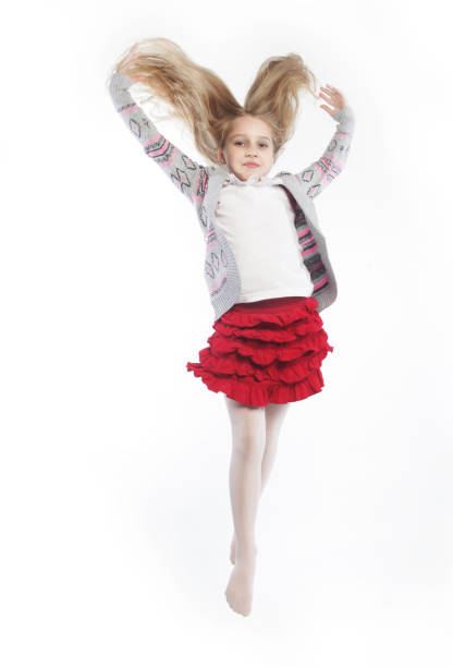 little girl jumps on a white background