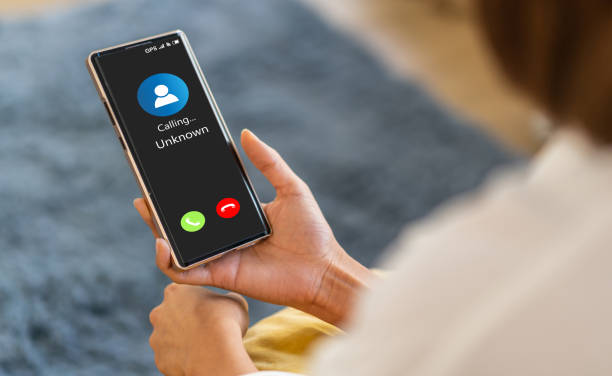 istock Human use smartphone with incoming call from unknown number, spam, prank caller, hoax person, fake identity, scammer, scam with mobile phone, hacker, call center, crime, call, fraud or phishing concept 2159474778