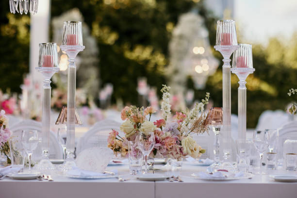 istock Beautiful table setting with crockery and flowers for a party, wedding reception or other festive event. Glassware and cutlery for catered event dinner. stock photo 2159476030