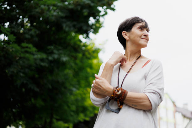 istock Stylish mature woman looking away outdoors in summer 2159476855